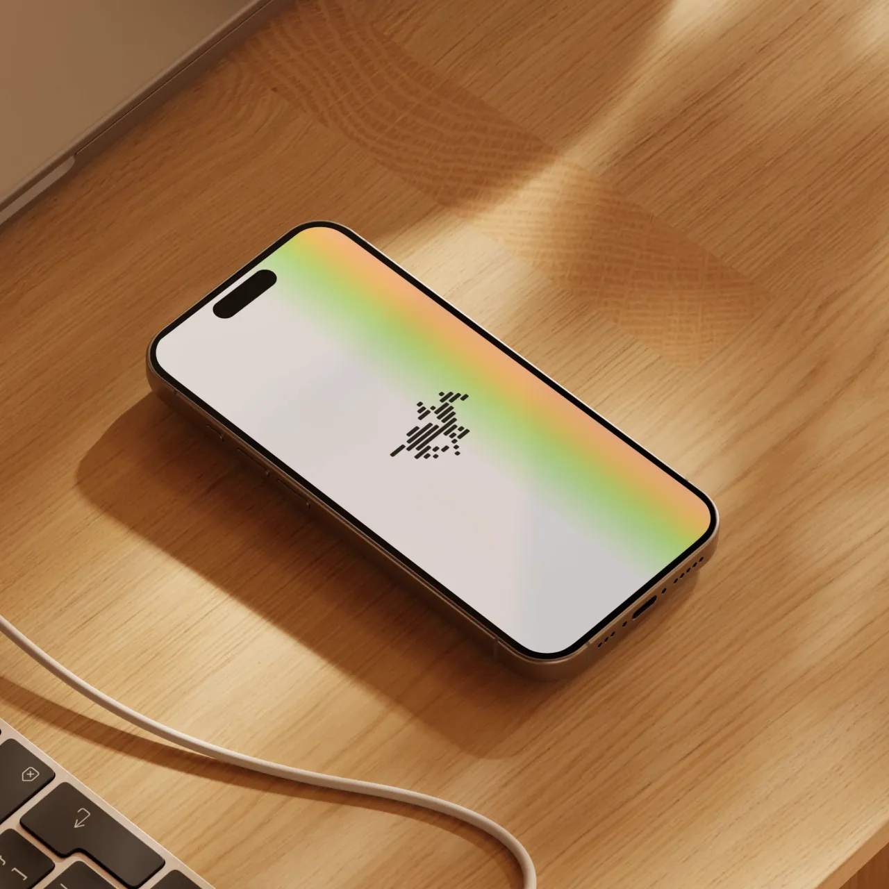 Smartphone on wooden surface displaying TwelveLabs' loading screen with a gradient overlay transitioning from yellow to green, beside a partially visible laptop keyboard