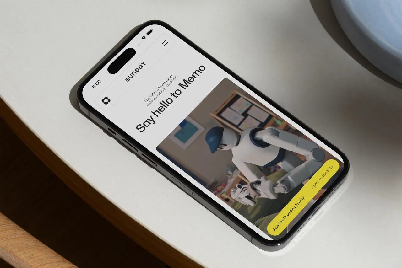 Smartphone displaying Sunday's website with "Say hello to Memo" headline and image of the home robot on a wooden surface